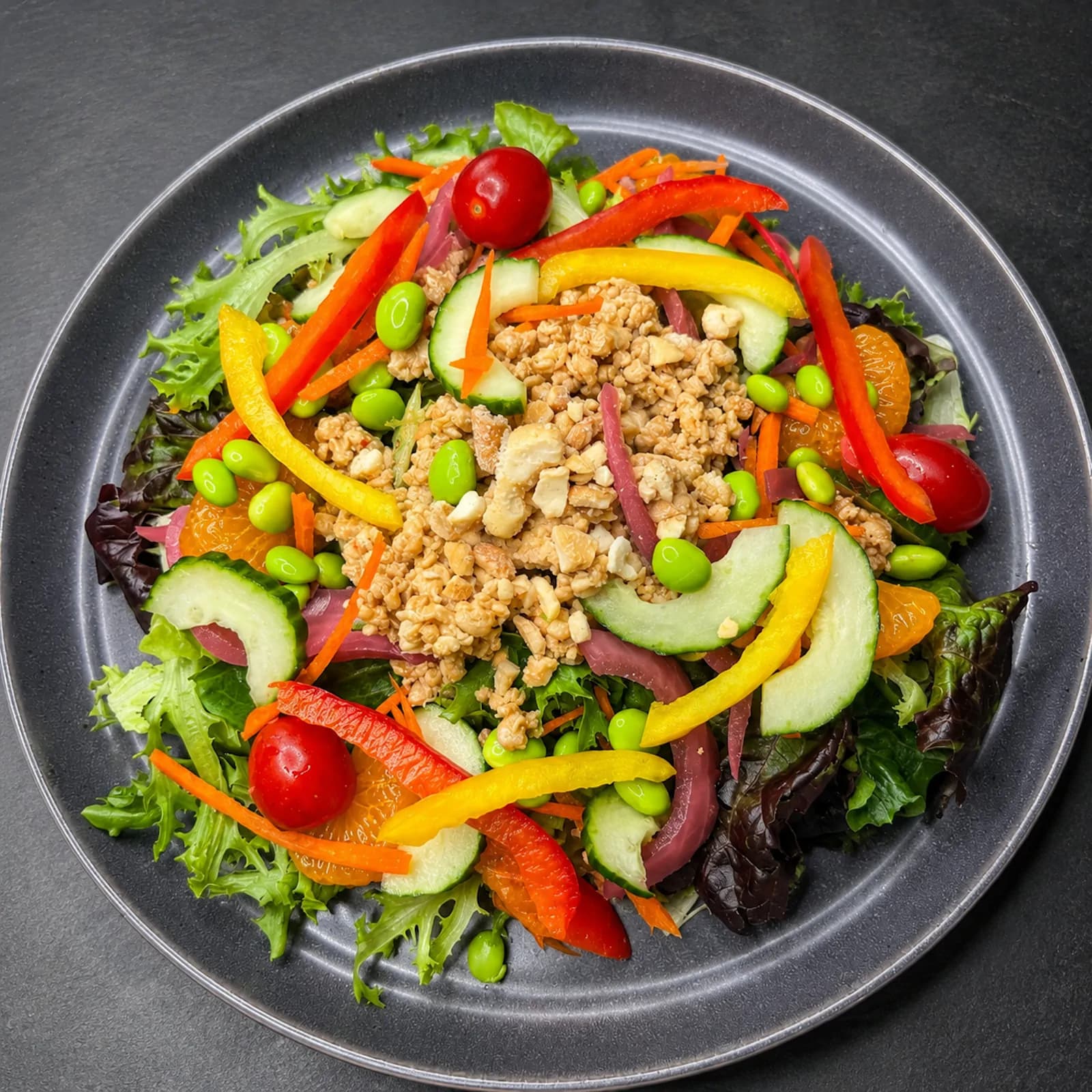 Chinese Mandarin Chicken Salad — sesame /soy ground chicken, Napa cabbage & mixed greens, edamame, mandarin oranges and sunflower seeds with citrus / soy vinaigrette